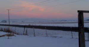 sunset reflected in clouds over snow