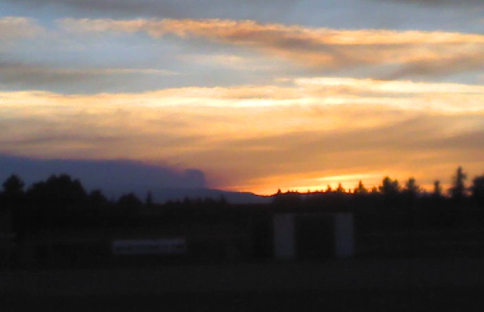 Smoke from one of our fires competes with sunset.