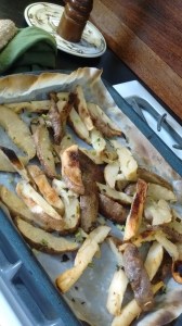 Oven-baked fries cooling on the baking sheet.